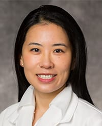 Amy Zhang, MD Headshot of a smiling woman with dark hair wearing a white collared shirt.